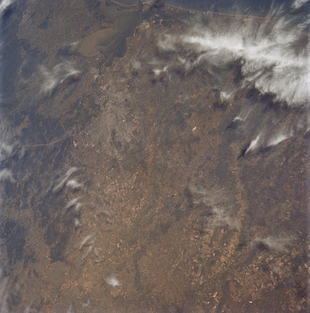 AS09-22-3463 (9 March 1969) --- Oblique view of the Houston, Texas area as photographed from the Apollo 9 spacecraft during its Earth-orbital mission. This picture was taken from an altitude of 103 nautical miles, at about 1:40 p.m. (CST), on March 9, 1969. Prominent features visible include highways leading out of the city, Lake Houston, San Jacinto River, Trinity Bay, Galveston Bay, Brazos River, Baytown, and Texas City.