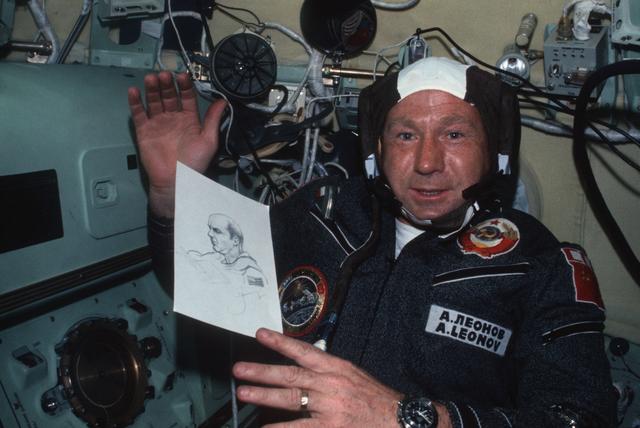 NASA image: Cosmonaut Aleksey Leonov displays drawing of Astronaut Thomas Stafford
