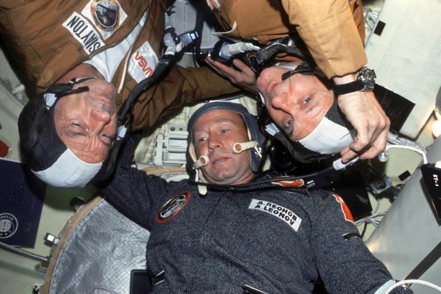 NASA image: Astronauts Stafford and Slayton and Cosmonaut Leonov in Soyuz Orbital Module