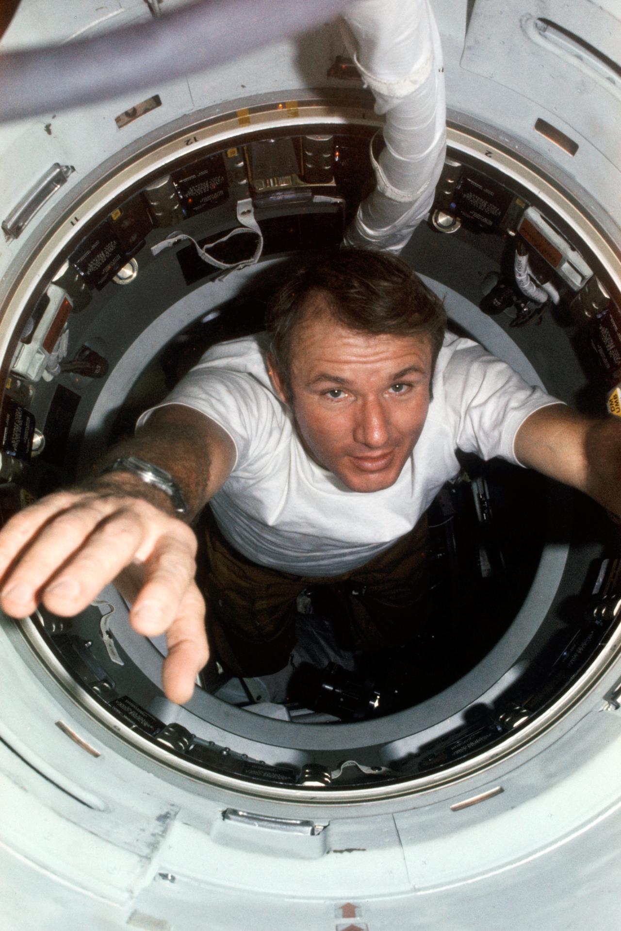Vance Brand floating through the hatchway between the Apollo and Soyuz spacecraft