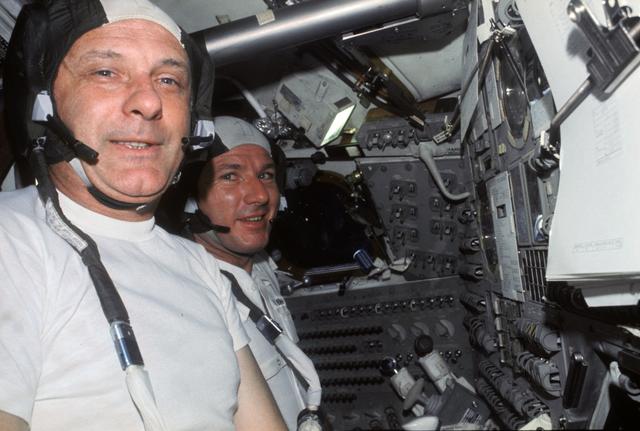 NASA image: Astronauts Stafford and Brand at controls of Apollo Command Module