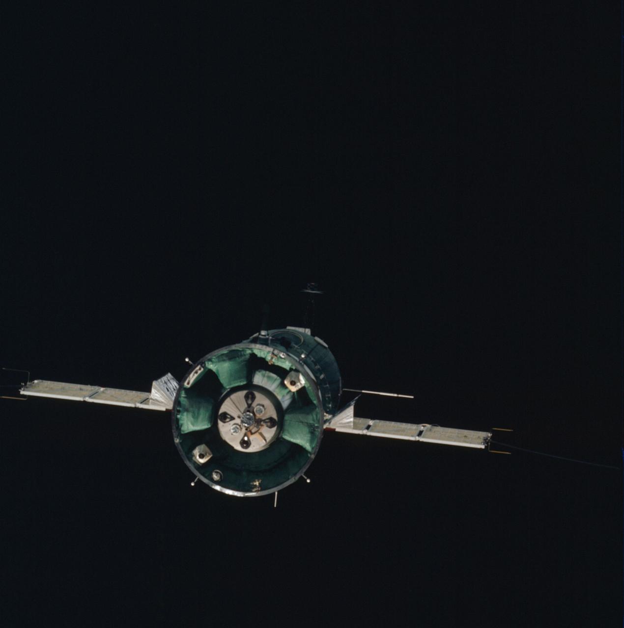 AST-01-053 (17-19 July 1975) --- The Soviet Soyuz spacecraft is contrasted against a black-sky background in this photograph taken in Earth orbit. This view is looking toward the aft end of the Soyuz. Two solar panels protrude out from the spacecraft's Instrument Assembly Module. The ASTP astronauts and cosmonauts visited each other's spacecraft while the Soyuz and Apollo were docked in Earth orbit for two days.