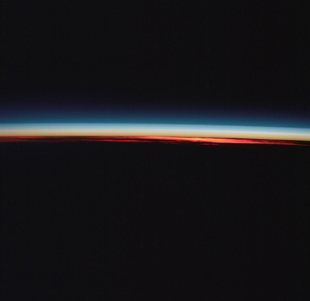 AST-27-2339 (20 July 1975) --- The Earth’s limb at sunrise and cloud silhouettes in the Southern Hemisphere, as photographed from the Apollo spacecraft during the joint U.S.-USSR Apollo-Soyuz Test Project mission. The photograph was taken at an altitude of 230 kilometers (143 statute miles) with a 70mm Hasselblad camera using medium-speed Ektachrome QX-807 type film.