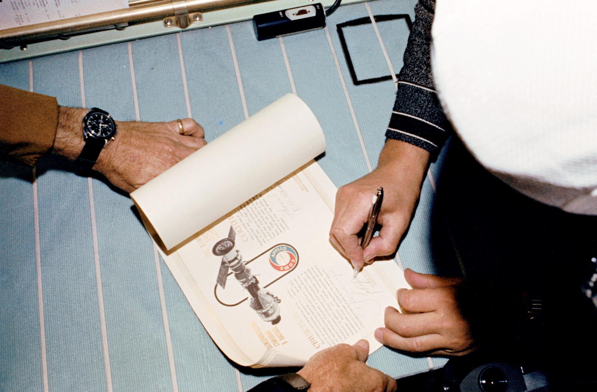 Valery Kubasov signs a certificate on the joint Apollo-Soyuz mission