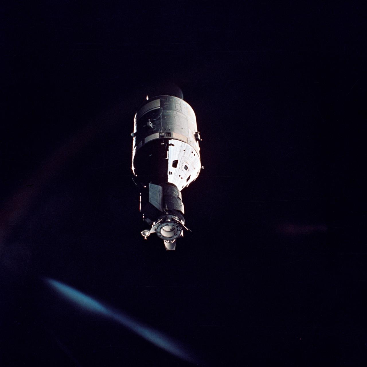AST-32-2686 (17-19 July 1975) --- The American Apollo spacecraft as seen in Earth orbit from the Soviet Soyuz 19 spacecraft during the joint U.S.-USSR Apollo Soyuz Test Project (ASTP) mission. The Command and Service Module (CSM) and Docking Module (DM) are contrasted against a black-sky background. Light reflected in the camera streaks the image.  Note the docking mechanism and docking target on the DM. On the left the bell-shaped engine nozzle of the service propulsion system protrudes from the rear of the Service Module (SM). The American and Soviet spacecraft were joined together in space for approximately 47 hours on July 17, 18, 19, 1975. This picture was furnished by the USSR in an exchange of photography taken during the ASTP flight.  The Apollo crew consisted of astronauts Thomas P. Stafford, commander; Donald K. "Deke" Slayton, docking module pilot; and Vance D. Brand, command module pilot. The Soyuz 19 crew consisted of cosmonauts Aleksei A. Leonov, command pilot; and Valeri N. Kubasov, flight engineer.
