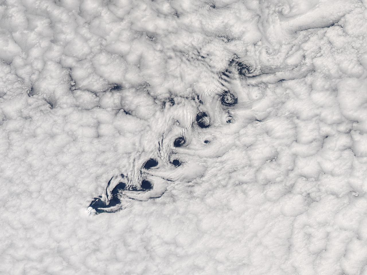 Cloud vortices off Heard Island, south Indian Ocean.  The Moderate Resolution Imaging Spectroradiometer (MODIS) aboard NASA’s Aqua satellite captured this true-color image of sea ice off Heard Island on Nov 2, 2015 at 5:02 AM EST (09:20 UTC).    Credit: NASA/GSFC/Jeff Schmaltz/MODIS Land Rapid Response Team