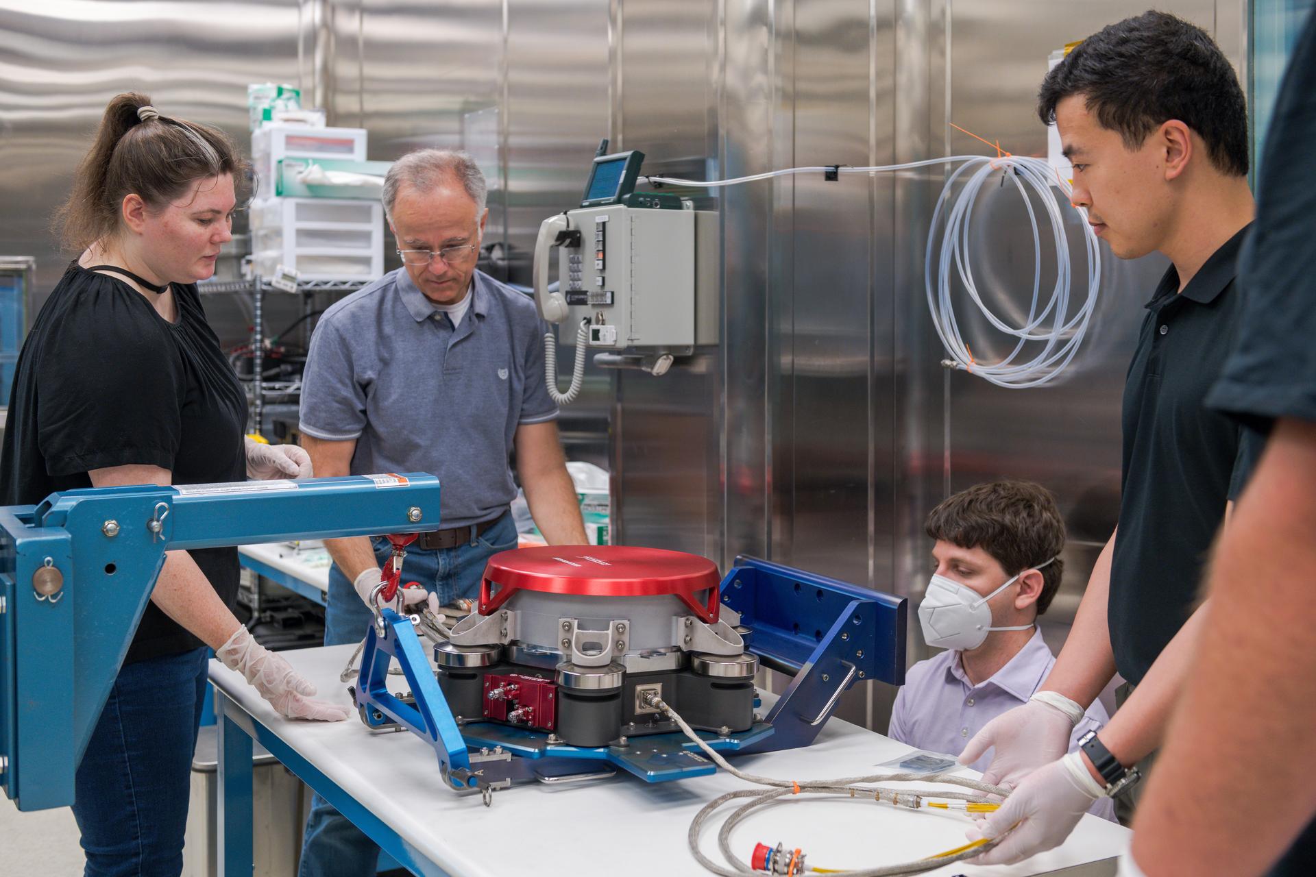 Engineers at NASA’s Glenn Research Center in Cleveland work together to position and secure the second of three Advanced Electric Propulsion System (AEPS) thrusters for acceptance testing. Following testing, the thruster was delivered to Lanteris Space Systems in Palo Alto, California, for installation on Gateway’s Power and Propulsion Element. Credit: NASA
