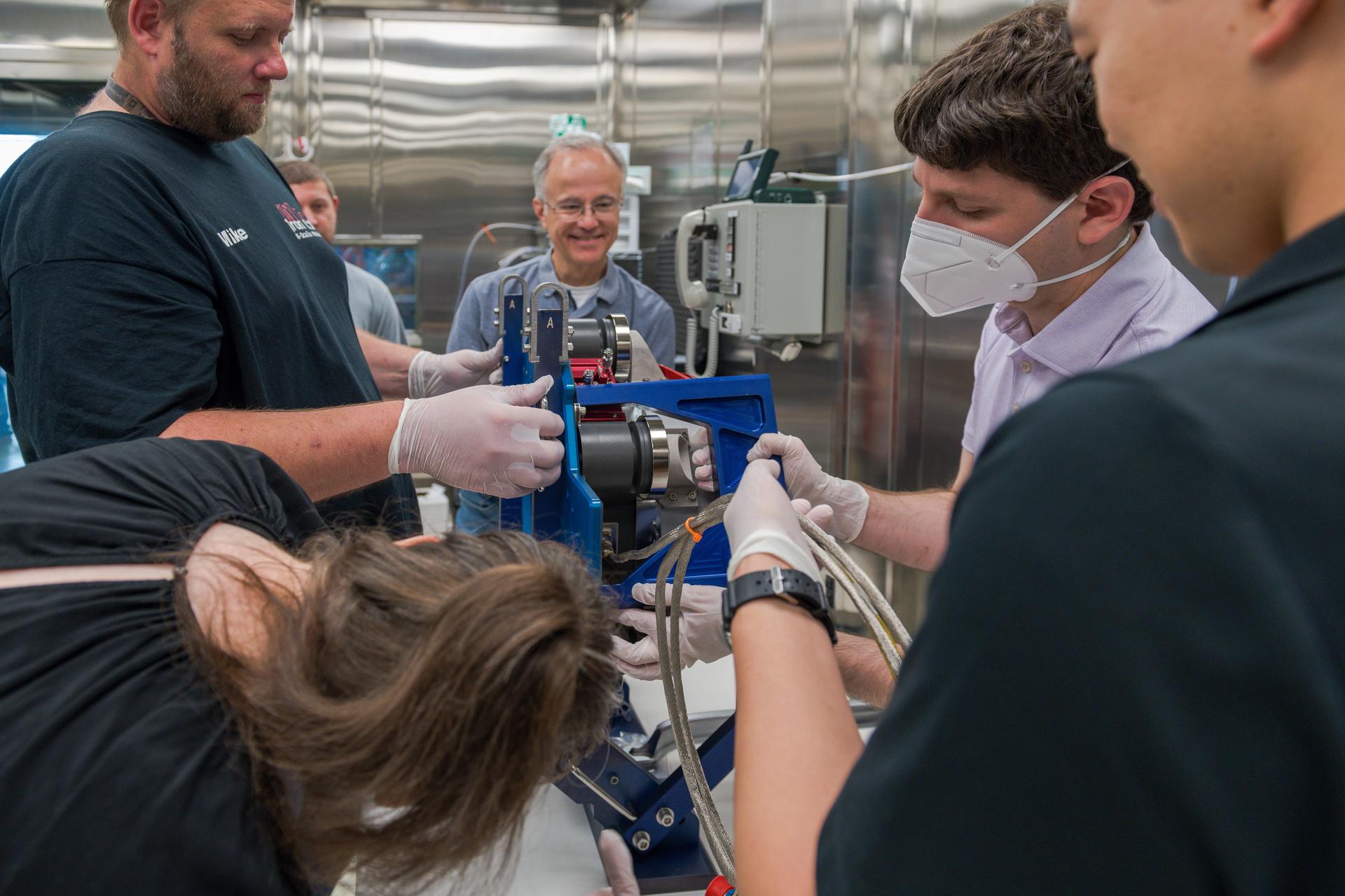 Engineers at NASA’s Glenn Research Center in Cleveland work together to position and secure the second of three Advanced Electric Propulsion System (AEPS) thrusters for acceptance testing. Following testing, the thruster was delivered to Lanteris Space Systems in Palo Alto, California, for installation on Gateway’s Power and Propulsion Element. Credit: NASA