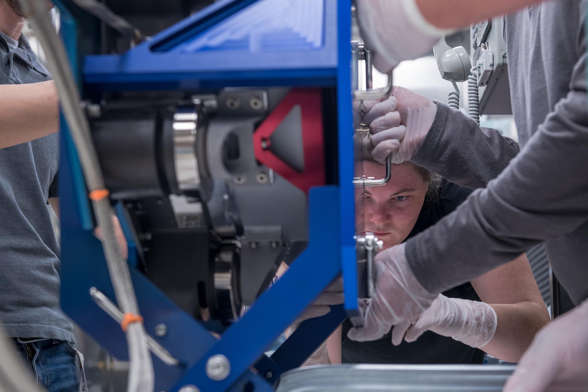 Engineers at NASA’s Glenn Research Center in Cleveland prepare the third and final Advanced Electric Propulsion System (AEPS) thruster for acceptance testing. Following successful testing, the thruster was delivered to Lanteris Space Systems in Palo Alto, California, for installation on the primary structure Gateway’s Power and Propulsion Element. Credit: NASA