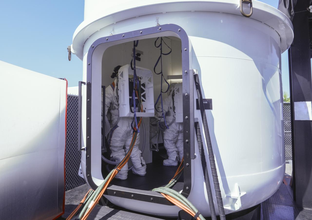 NASA astronaut Doug “Wheels” Wheelock and Axiom Space astronaut Peggy Whitson were fully suited while conducting mission-like maneuvers in the full-scale build of the Starship human landing system’s airlock which will be located inside Starship under the crew cabin. Image Credit: SpaceX