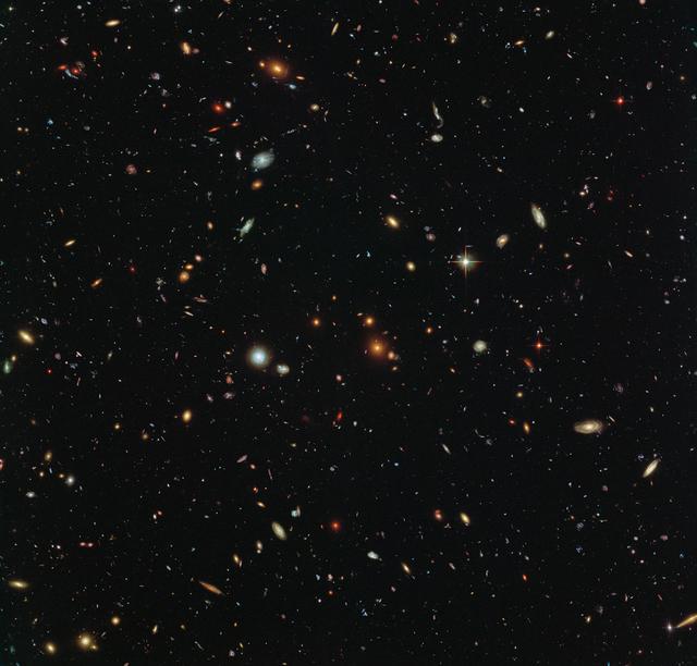 Peering deep into the early Universe, this picturesque parallel field observation from the NASA/ESA Hubble Space Telescope reveals thousands of colourful galaxies swimming in the inky blackness of space. A few foreground stars from our own galaxy, the Milky Way, are also visible. In October 2013 Hubble’s Wide Field Camera 3 (WFC3) and Advanced Camera for Surveys (ACS) began observing this portion of sky as part of the Frontier Fields programme. This spectacular skyscape was captured during the study of the giant galaxy cluster Abell 2744, otherwise known as Pandora’s Box. While one of Hubble’s cameras concentrated on Abell 2744, the other camera viewed this adjacent patch of sky near to the cluster. Containing countless galaxies of various ages, shapes and sizes, this parallel field observation is nearly as deep as the Hubble Ultra-Deep Field. In addition to showcasing the stunning beauty of the deep Universe in incredible detail, this parallel field — when compared to other deep fields — will help astronomers understand how similar the Universe looks in different directions