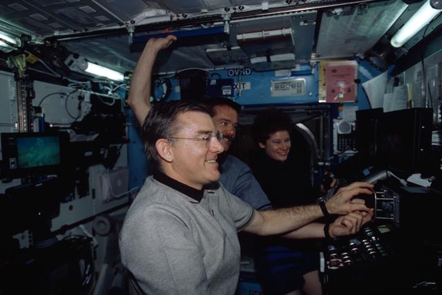 NASA image: Expedition Two Voss at SSRMS controls with Hadfield and Helms in Destiny module