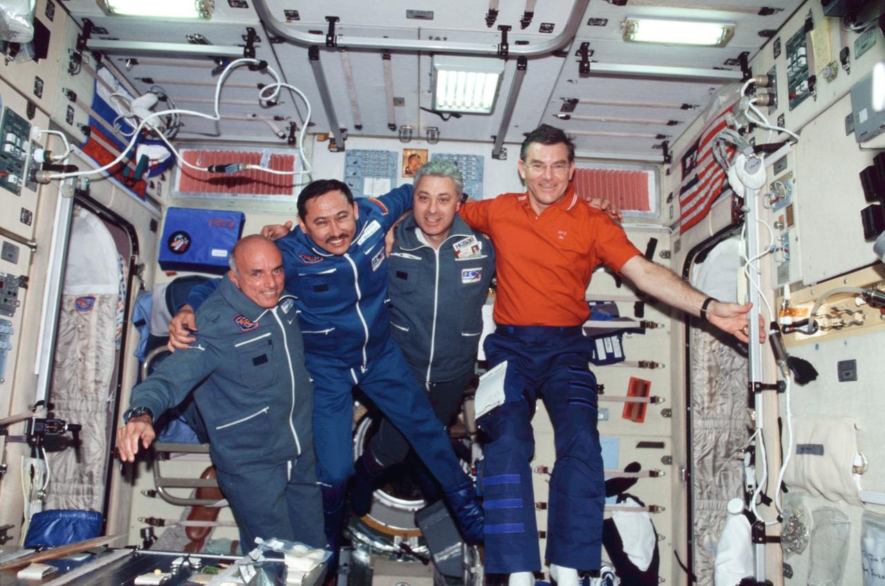 ISS002-356-012 (30 April &#0150; 5 May 2001) --- The Soyuz 2 crewmembers and astronaut James S. Voss (right), Expedition 2 flight engineer, pose for a group photo in the Zvezda Service Module on the International Space Station (ISS). From the left are American businessman Dennis Tito; and cosmonauts Talgat Musabayev and Yuri Baturin, Soyuz 2 commander and flight engineer, respectively, representing Rosaviakosmos.