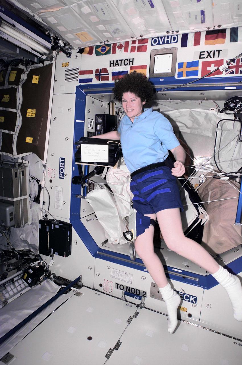 ISS002-E-5052 (March 2001) --- Astronaut Susan J. Helms, Expedition Two flight engineer, totes computer hardware on the Destiny laboratory. Helms, along with cosmonaut Yury V. Usachev of Rosaviakosmos and astronaut James S. Voss, recently took over residency on the International Space Station (ISS) from a three-member crew who had been on board since early November 2000. The image was recorded with a digital still camera.