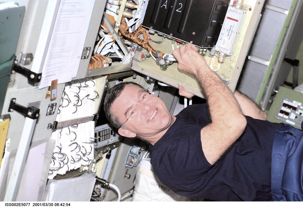 ISS002-E-5077 (30 March 2001) --- Astronaut James S. Voss, Expedition Two flight engineer, performs an electronics maintenance task in the Zvezda Service Module aboard the International Space Station (ISS).  The photo was recorded with a digital still camera.
