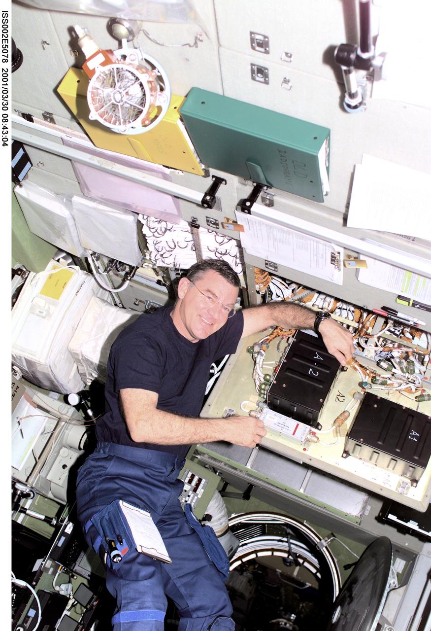 ISS002-E-5078 (30 March 2001) --- Astronaut James S. Voss, Expedition Two flight engineer, conducts electronics maintenance on the Zvezda / Service Module aboard the International Space Station (ISS).  This image was recorded with a digital still camera.(ISS).  This image was recorded with a digital still camera.