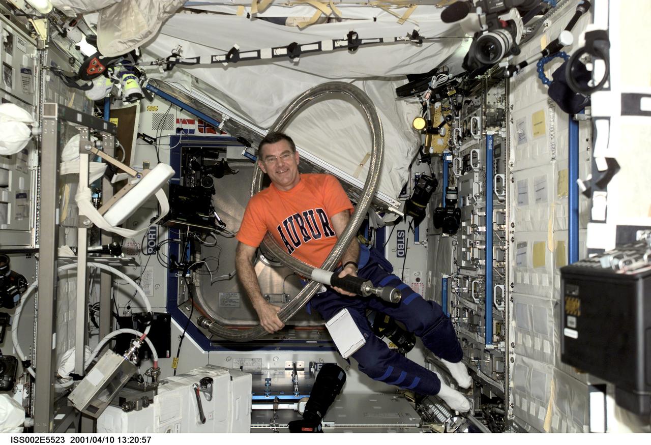 ISS002-E-5523 (10 April 2001) --- Astronaut James S. Voss, Expedition Two flight engineer, jokingly wraps a large hose around his body prior to installing it in the U.S. Laboratory / Destiny module of the International Space Station (ISS). This image was recorded with a digital still camera.