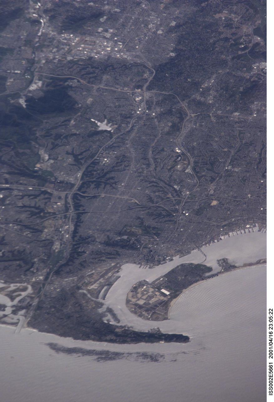 ISS002-E-5661 (16 April 2001) --- As the International Space Station (ISS) recently passed over the Pacific Ocean, one of the Expedition Two crew members, using an 800mm lens on a digital still camera, photographed this high oblique image of the coastal metropolitan area of San Diego, California.  The angle of the view allows one to see quite a distance inland.