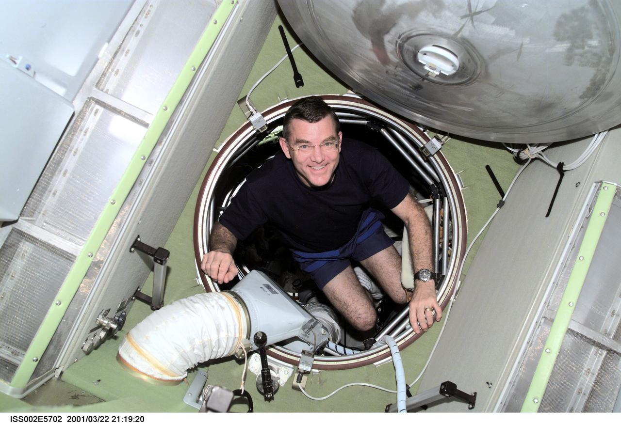 ISS002-E-5702 (22 March 2001) --- Astronaut James S. Voss, Expedition Two flight engineer, translates through the forward hatch of the Zvezda Service Module. The image was recorded with a digital still camera.