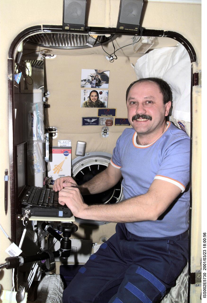ISS002-E-5730 (23 March 2001) --- Cosmonaut Yury V. Usachev, Expedition Two commander, works at a laptop computer in his crew compartment in the Zvezda Service Module aboard the International Space Station (ISS).  The image was recorded with a digital still camera.