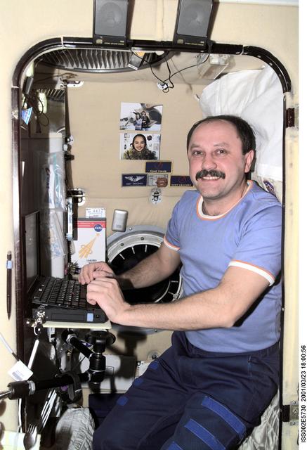 NASA image: Usachev typing while in sleep station in the Service Module