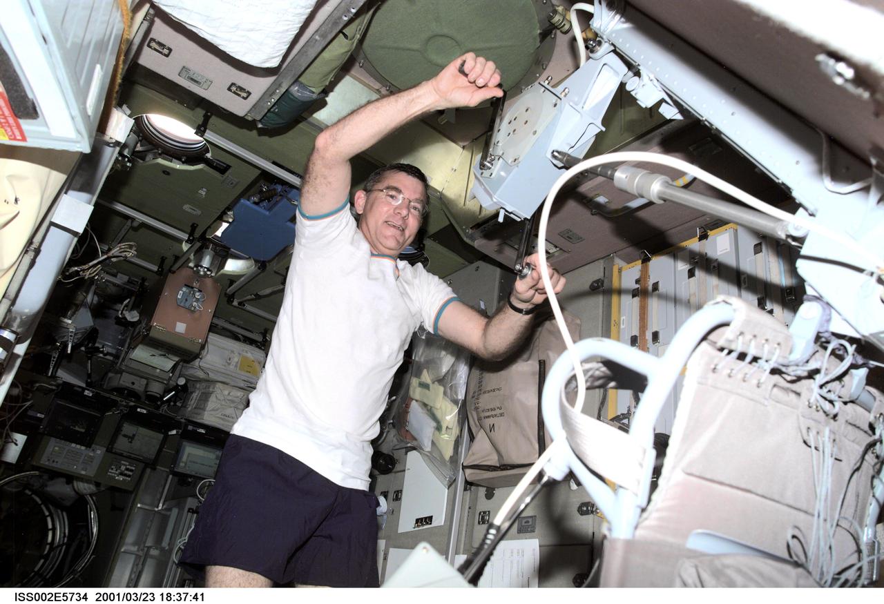 ISS002-E-5734 (23 March 2001) --- Astronaut James S. Voss, Expedition Two flight engineer, gives his arms and upper body a workout with the bicycle ergometer facility in the Zvezda Service Module aboard the International Space Station (ISS).  The image was recorded with a digital still camera.