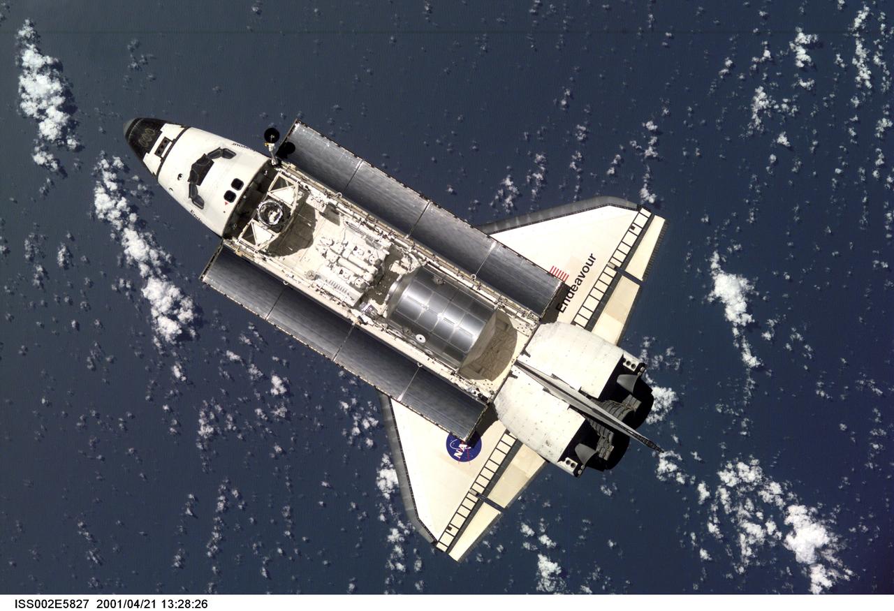 ISS02-E-5827 (21 April 2001) --- The Space Shuttle Endeavour, with six astronauts and a cosmonaut onboard,  approaches the International Space Station (ISS) for an April 21 docking.  The photo was taken with a digital still camera by one of the three Expedition Two crew members onboard the Station.