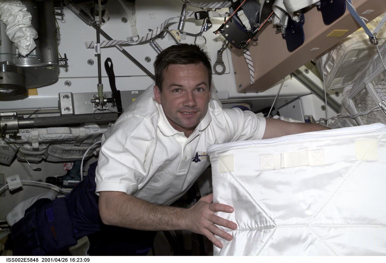 ISS002-E-5848 (26 April 2001) --- Yuri V. Lonchakov of Rosaviakosmos, STS-100 mission specialist, carries a stowage bag through Unity Node 1 during STS-100's visit to the International Space Station (ISS). The image was taken with a digital still camera.
