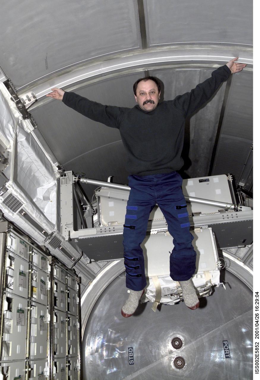 ISS002-E-5852 (26 April 2001) --- Yury V. Usachev of Rosaviakosmos, Expedtion Two mission commander, enjoys the extra space provided by the Multipurpose Logistics Module (MPLM) Raphaello which was mated to the International Space Station (ISS) during the STS-100 mission.  The image was taken with a digital still camera.