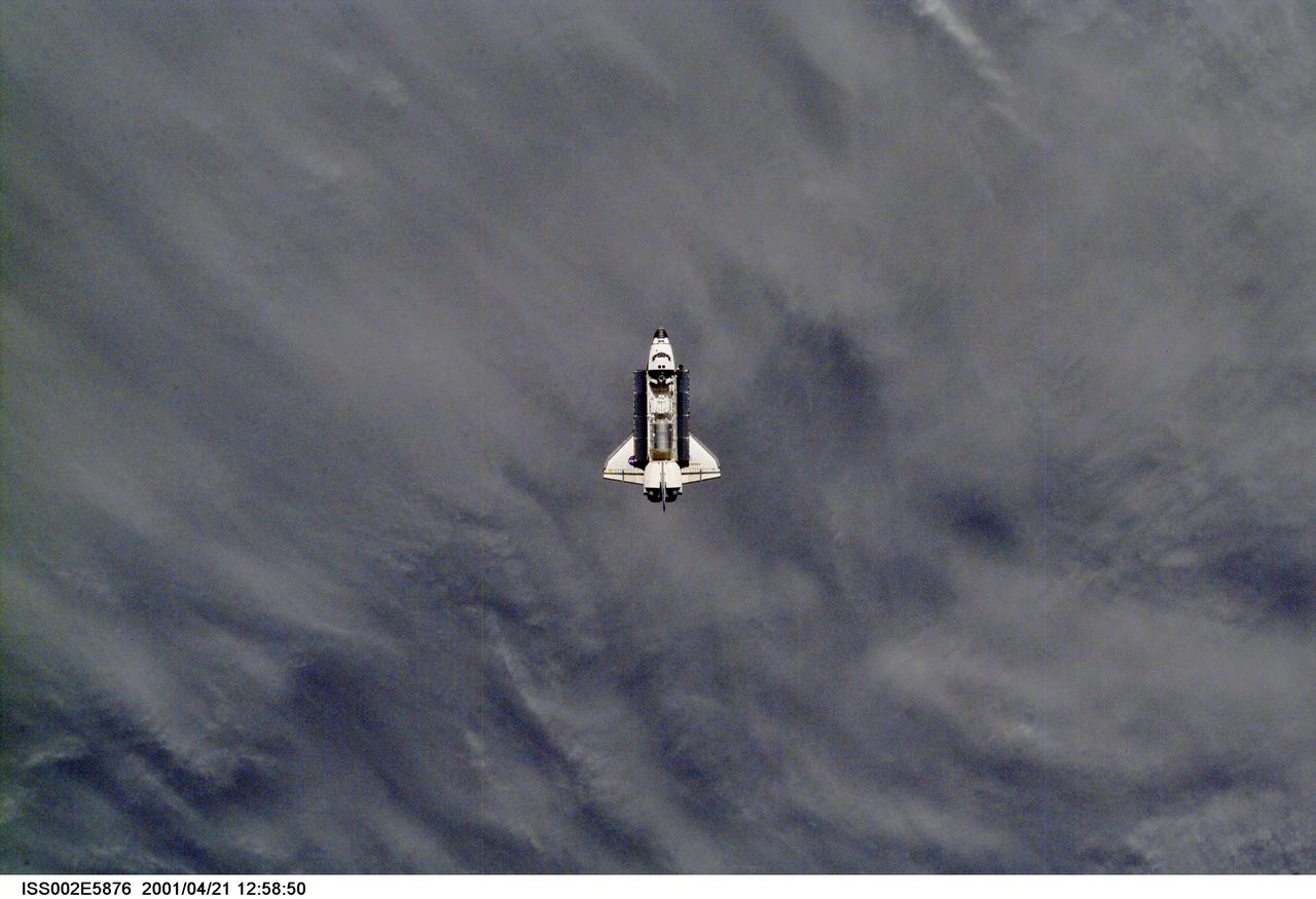 ISS002-E-5876 (21 April 2001) --- A distant view of the Space Shuttle Endeavour preparing to dock with the International Space Station (ISS) during the STS-100 mission.  The STS-100 crewmembers are delivering the Canadarm2, Space Station Remote Manipulator System (SSRMS), and equipment stowed in the Multipurpose Logistics Module (MPLM) Raphaello to the ISS which are visible in Endeavour's payload bay.  The image was taken with a digital still camera.