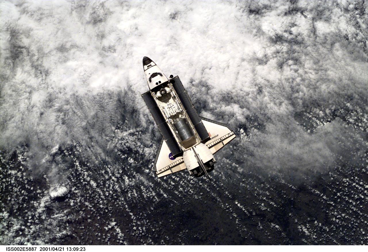 ISS002-E-5887 (21 April 2001) --- A view of the Space Shuttle Endeavour preparing to dock with the International Space Station (ISS) during the STS-100 mission.  The STS-100 crewmembers are delivering the Canadarm2, Space Station Remote Manipulator System (SSRMS), and equipment stowed in the Multipurpose Logistics Module (MPLM) Raphaello to the ISS which are visible in Endeavour's payload bay.  The image was taken with a digital still camera.