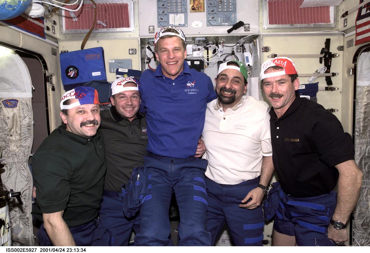 ISS002-E-5927 (24 April 2001) --- Yury V. Usachev, Expedition Two mission commander with STS-100 mission specialists Yuri V. Lonchakov, Scott E. Parazynski, Umberto Guidoni and Chris A. Hadfield, in the Zvezda Service Module, all sport baseball caps representing their home countries, showing the true flavor of the International Space Station (ISS). Usachev and Lonchakov represent Rosaviakosmos, Guidoni represents the European Space Agency (ESA), Parazynski represents NASA, and Hadfield represents the Canadian Space Agency (CSA). The image was taken with a digital still camera.