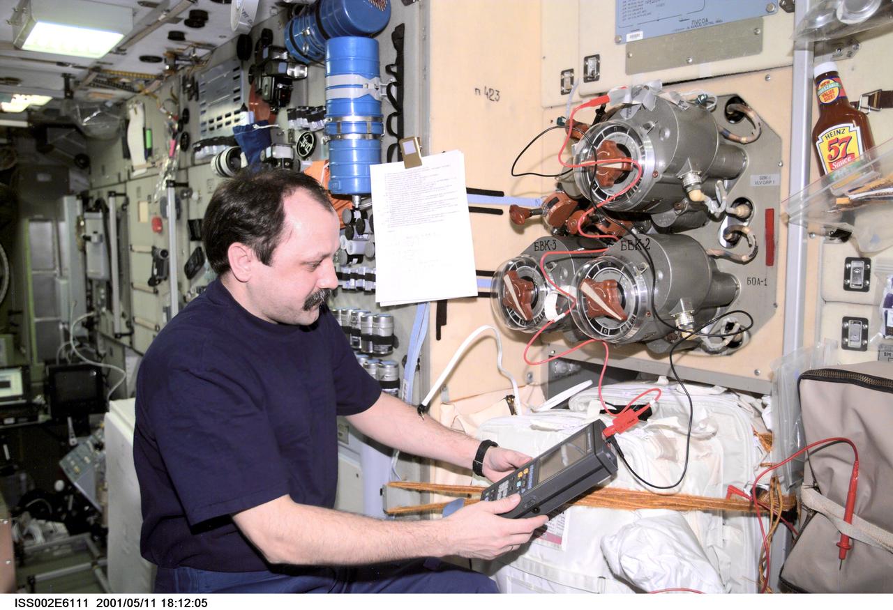 ISS002-E-6111 (11 May 2001) --- Yury V. Usachev of Rosaviakosmos, Expedition Two mission commander, tests the Vozdukh Air Purification System in the Zvezda Service Module.  The image was taken with a digital still camera.