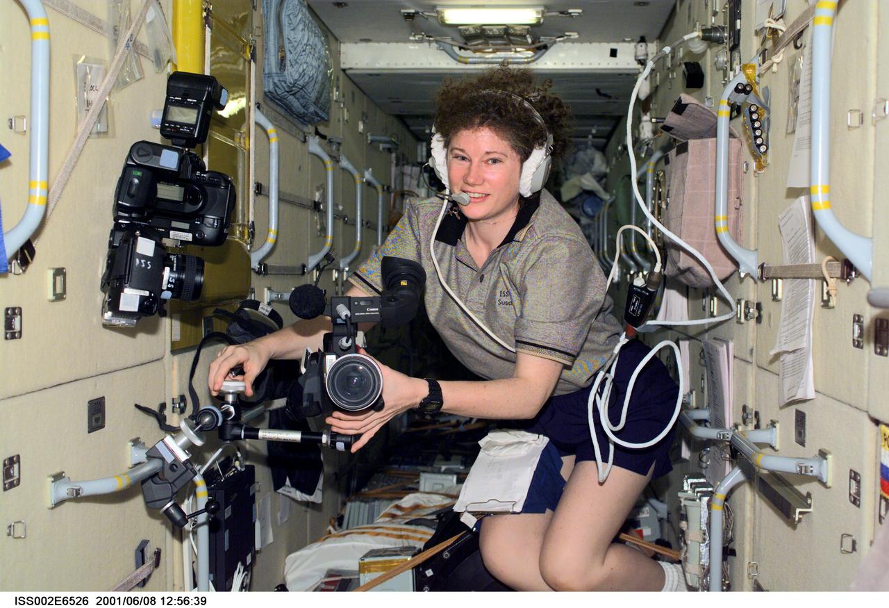 ISS002-E-6526 (8 June 2001) --- Astronaut Susan J. Helms, Expedition Two flight engineer, mounts a video camera onto a bracket in the Zarya or Functional Cargo Block (FGB) of the International Space Station (ISS). The image was recorded with a digital still camera. Alternate NASA ID of 0202499.