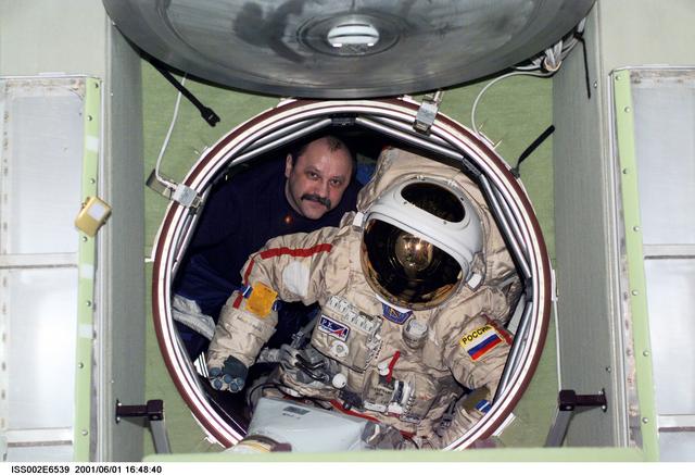 NASA image: Usachev moves Orlan suit in forward hatch of Zvezda module