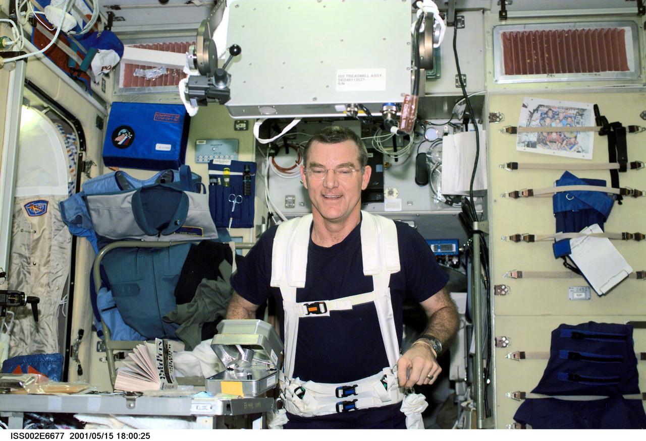 ISS002-E-06677 (15 May 2001) --- James S. Voss, Expedition Two flight engineer, wearing a safety harness, exercises on the Treadmill Vibration Isolation System (TVIS) equipment in the Zvezda Service Module. This image was taken with a digital still camera.