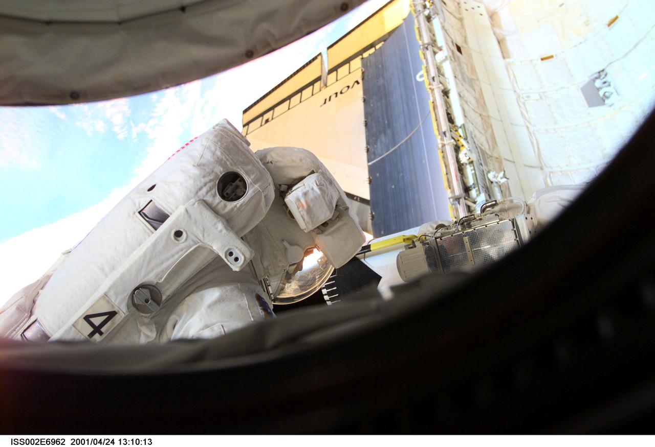 ISS002-E-6962 (24 April 2001) --- Astronaut Scott E. Parazynski, STS-100 mission specialist, performs a task during the second space walk (EVA-2). A digital still camera on the International Space Station (ISS) was used to record this image.