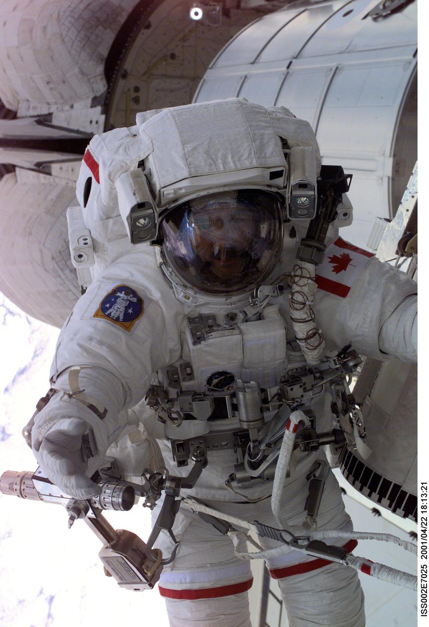 ISS002-E-7025 (22 April 2001) --- Astronaut Chris A.  Hadfield, mission specialist representing the Canadian Space Agency (CSA), is seen during the first space walk (EVA-1) of the STS-100 mission.  The picture taken with a digital still camera through the nadir window of the Destiny/U.S. Laboratory.