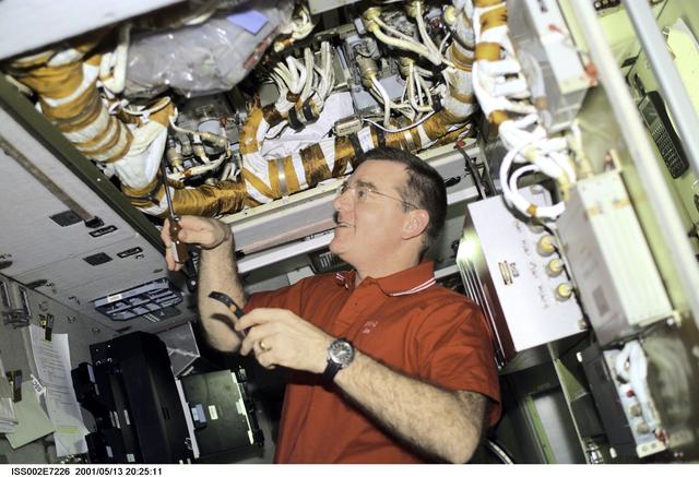 NASA image: Voss works with cables in panel in the Service Module
