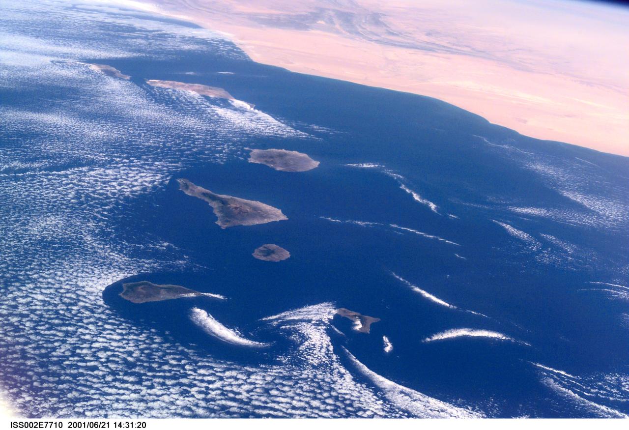 ISS002-E-7710 (21 June 2001) --- Commonly visible cloud vortices hover in the area of the Canary Islands off the coast of Morocco in this Expedition Two digital still camera's view from the International Space Station (ISS).