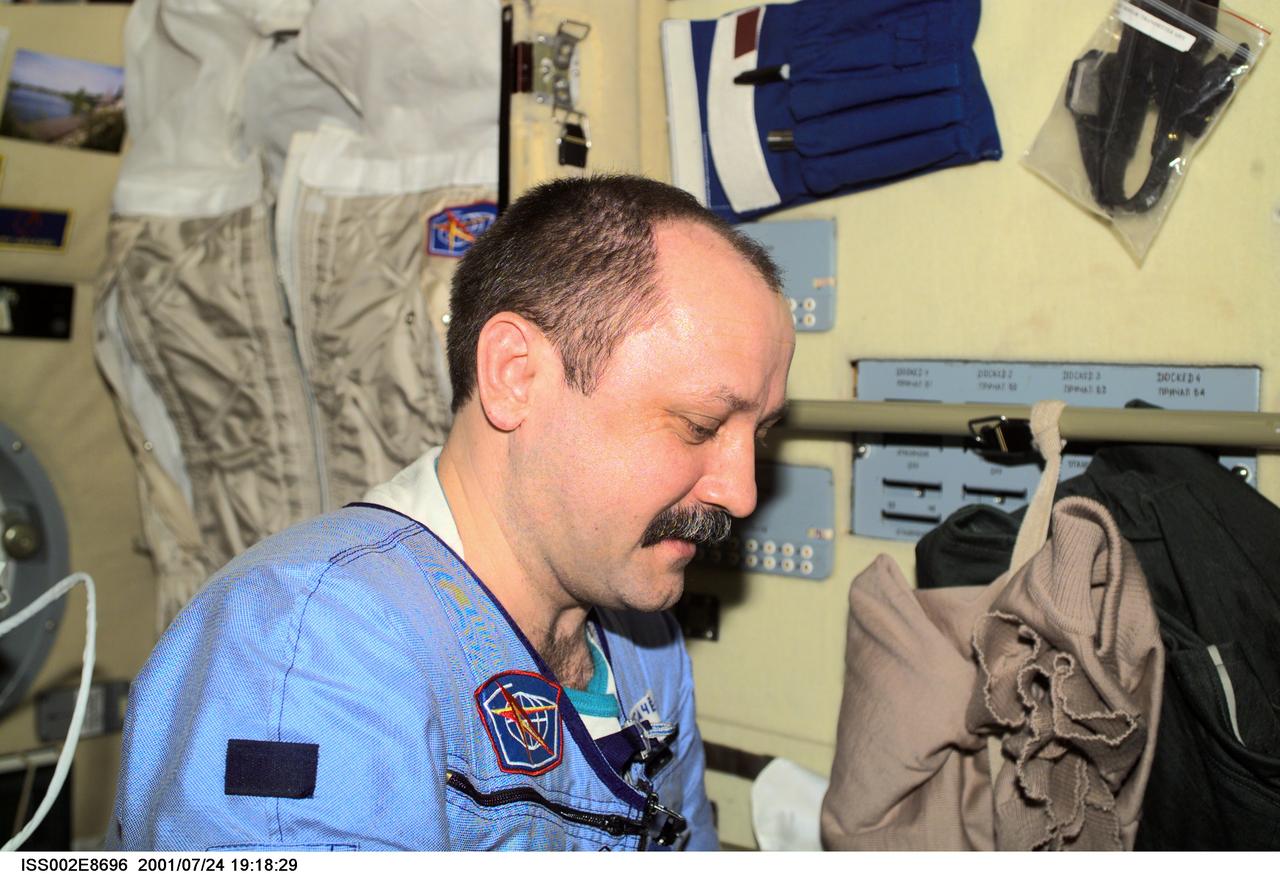 ISS002-E-8696 (24 July 2001) --- Cosmonaut Yury V. Usachev of Rosaviakosmos, Expedition Two commander,  was photographed in the Zvezda Service Module with a digital still camera.  Usachev and two NASA astronauts are in the last few weeks of a lengthy stay aboard the International Space Station (ISS).