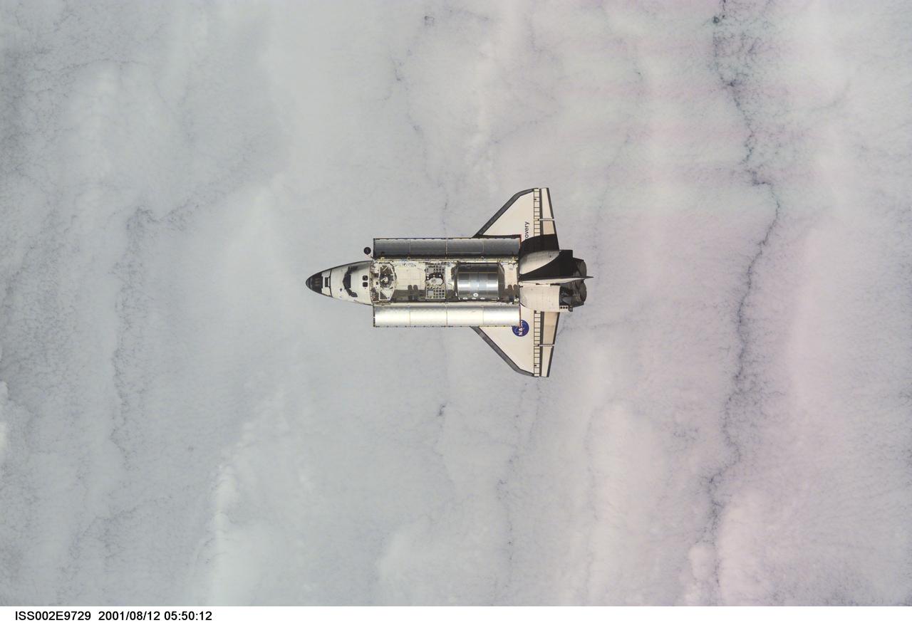 ISS002-E-9729 (12 August 2001) --- View of the Space Shuttle Discovery as it approaches the International Space Station (ISS) during the STS-105 mission. Aboard Discovery are the members of the Expedition Three crew - Frank L. Culbertson, Jr., mission commander, and cosmonauts Vladimir N. Dezhurov and Mikhail Tyurin, flight engineers - who will be replacing the Expedition Two crew that has been living on the ISS for the past five months. Visible in the payload bay of Discovery are the Multipurpose Logistics Module (MPLM) Leonardo, which stores various supplies and experiments to be transferred into the ISS; and the Integrated Cargo Carrier (ICC) which carries the Early Ammonia Servicer (EAS) and two Materials International Space Station Experiment (MISSE) containers. This image was taken with a digital still camera.
