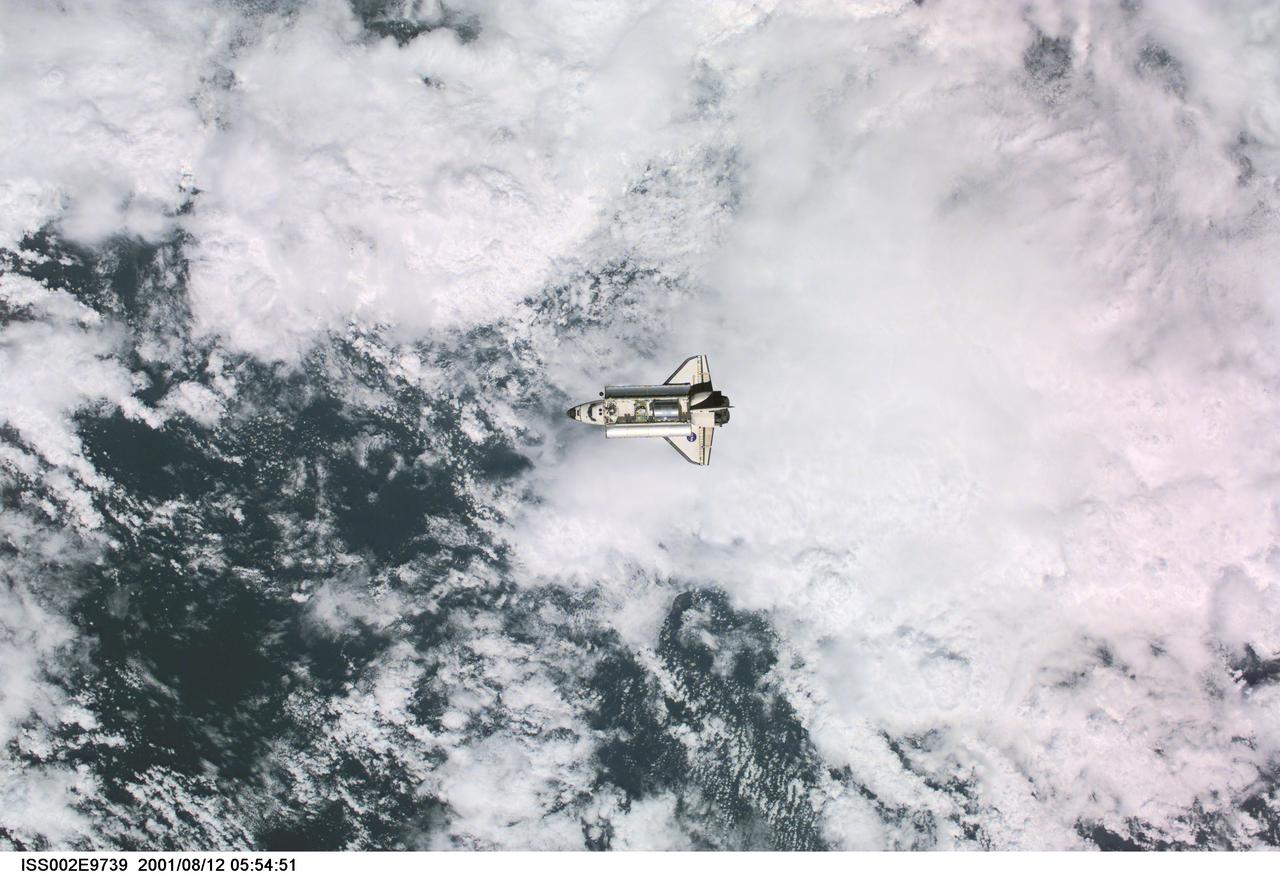 ISS002-E-9739 (12 August 2001) --- View of the Space Shuttle Discovery as it approaches the International Space Station (ISS) during the STS-105 mission. Aboard Discovery are the members of the Expedition Three crew - Frank L. Culbertson, Jr., mission commander, and cosmonauts Vladimir N. Dezhurov and Mikhail Tyurin, flight engineers - who will be replacing the Expedition Two crew that has been living on the ISS for the past five months. Visible in the payload bay of Discovery are the Multipurpose Logistics Module (MPLM) Leonardo, which stores various supplies and experiments to be transferred into the ISS; and the Integrated Cargo Carrier (ICC), which carries the Early Ammonia Servicer (EAS) and two Materials International Space Station Experiment (MISSE) containers. This image was taken with a digital still camera.
