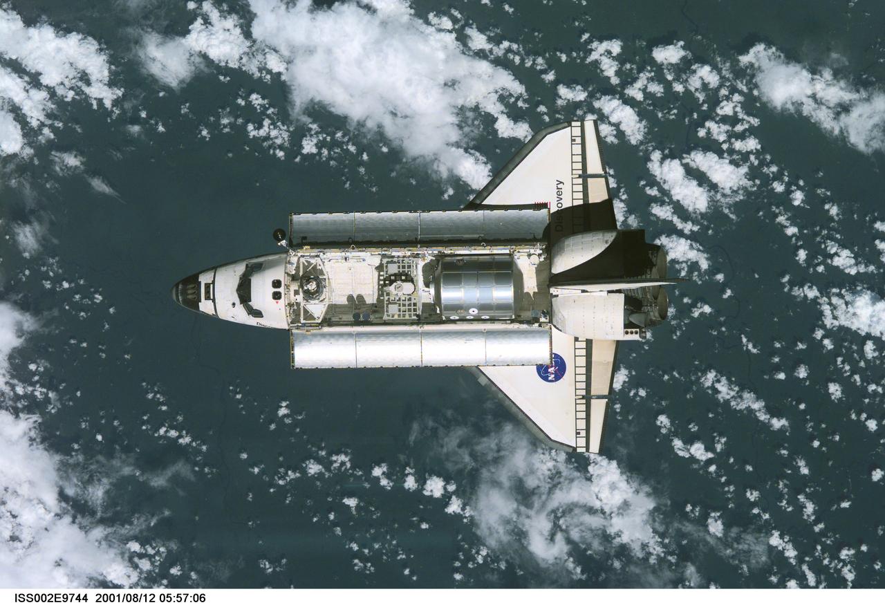 ISS002-E-9744 (12 August 2001) --- View of the Space Shuttle Discovery as it approaches the International Space Station (ISS) during the STS-105 mission. Aboard Discovery are the members of the Expedition Three crew - Frank L. Culbertson, Jr., mission commander, and cosmonauts Vladimir N. Dezhurov and Mikhail Tyurin, flight engineers - who will be replacing the Expedition Two crew that has been living on the ISS for the past five months. Visible in the payload bay of Discovery are the Multipurpose Logistics Module (MPLM) Leonardo, which stores various supplies and experiments to be transferred into the ISS; and the Integrated Cargo Carrier (ICC) which carries the Early Ammonia Servicer (EAS) and two Materials International Space Station Experiment (MISSE) containers. This image was taken with a digital still camera.