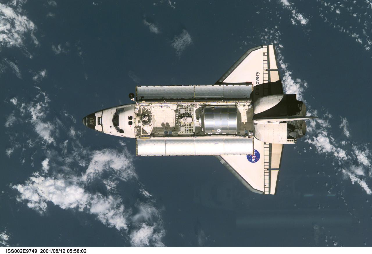 ISS002-E-9749 (12 August 2001) --- View of the Space Shuttle Discovery as it approaches the International Space Station (ISS) during the STS-105 mission. Aboard Discovery are the members of the Expedition Three crew - Frank L. Culbertson, Jr., mission commander, and cosmonauts Vladimir N. Dezhurov and Mikhail Tyurin, flight engineers - who will be replacing the Expedition Two crew that has been living on the ISS for the past five months. Visible in the payload bay of Discovery are the Multipurpose Logistics Module (MPLM) Leonardo, which stores various supplies and experiments to be transferred into the ISS; and the Integrated Cargo Carrier (ICC) which carries the Early Ammonia Servicer (EAS) and two Materials International Space Station Experiment (MISSE) containers. This image was taken with a digital still camera.