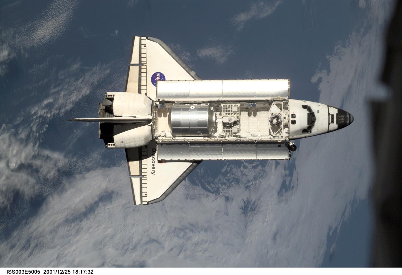 ISS003-E-5005 (12 August 2001) --- The Space Shuttle Discovery approaches the International Space Station (ISS) during the STS-105 mission. Aboard Discovery are the members of the Expedition Three crew -- Frank L. Culbertson, mission commander, and cosmonauts Vladimir N. Dezhurov and Mikhail Tyurin, flight engineers -- who will be replacing the Expedition Two crew that has been living on the ISS for the past five months. This image was taken by an Expedition Two crew member with a digital still camera.
