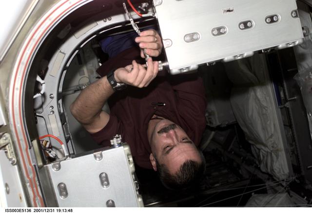 NASA image: Tyurin works on a CPA in the hatch between the MPLM and Node 1
