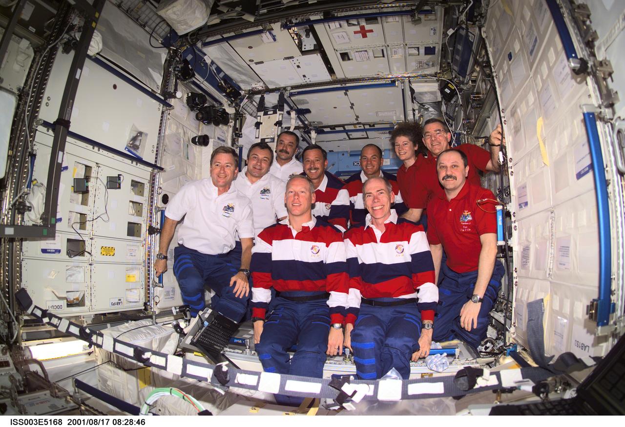 ISS003-E-5168 (17 August 2001) --- The Expedition Three (white shirts), STS-105 (striped shirts), and Expedition Two (red shirts) crews assemble for a group photo in the Destiny laboratory on the International Space Station (ISS). The Expedition Three crew members are, from front to back, Frank L. Culbertson, Jr., mission commander; and cosmonauts Vladimir N. Dezhurov and Mikhail Tyurin, flight engineers; STS-105 crew members are, front row, Patrick G. Forrester and Daniel T. Barry, mission specialists, and back row, Scott J. Horowitz, commander, and Frederick W. (Rick) Sturckow, pilot; Expedition Two crew members are, from front to back, cosmonaut Yury V. Usachev, mission commander, James S. Voss and Susan J. Helms, flight engineers. Dezhurov, Tyurin and Usachev represent Rosaviakosmos. This image was taken with a digital still camera.