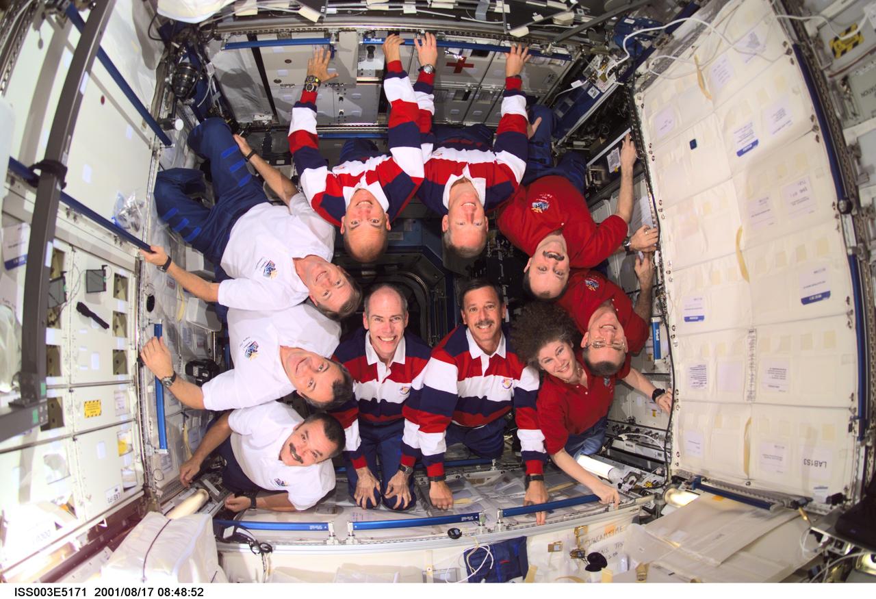 ISS003-E-5171 (17 August 2001) --- The Expedition Three (white shirts), STS-105 (striped shirts), and Expedition Two (red shirts) crews assemble for a group photo in the Destiny laboratory on the International Space Station (ISS). The Expedition Three crew members are, from bottom to top, cosmonauts Mikhail Tyurin and Vladimir N. Dezhurov, both flight engineers, and Frank L. Culbertson, Jr., mission commander; STS-105 crew members are, front row, Daniel T. Barry, mission specialist, and Scott J. Horowitz, commander, back row, Frederick W. (Rick) Sturckow, pilot, and Patrick G. Forrester, mission specialist; Expedition Two crew members are, from top to bottom, cosmonaut Yury V. Usachev, mission commander, James S. Voss and Susan J. Helms, flight engineers. Dezhurov, Tyurin and Usachev represent Rosaviakosmos. This image was taken with a digital still camera.