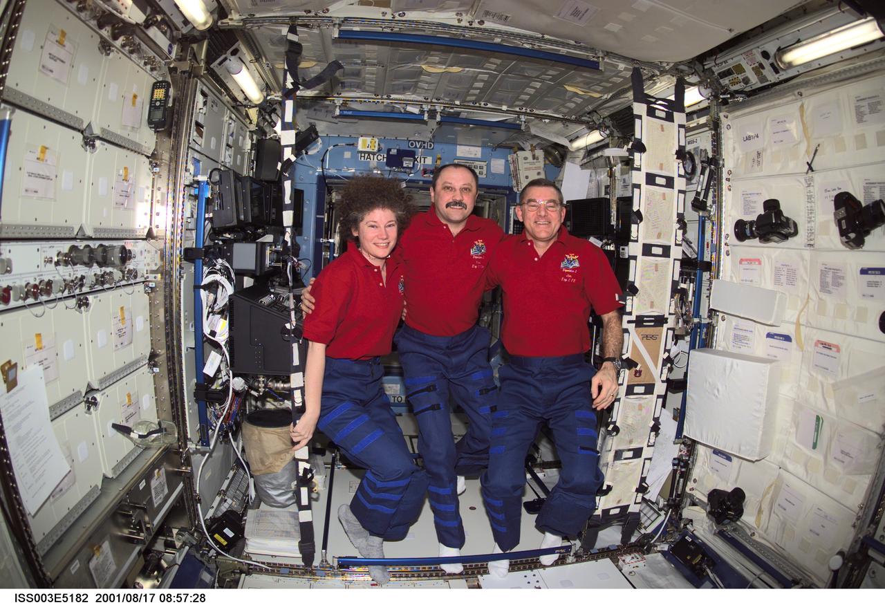 ISS003-E-5182 (17 August 2001) --- The Expedition Two crew members pause from their daily activities to pose for a group photo in the Destiny laboratory on the International Space Station (ISS). From left to right are, astronaut Susan J. Helms, flight engineer, cosmonaut Yury V. Usachev, mission commander, and astronaut James S. Voss, flight engineer. Usachev represents Rosaviakosmos. This image was taken with a digital still camera.